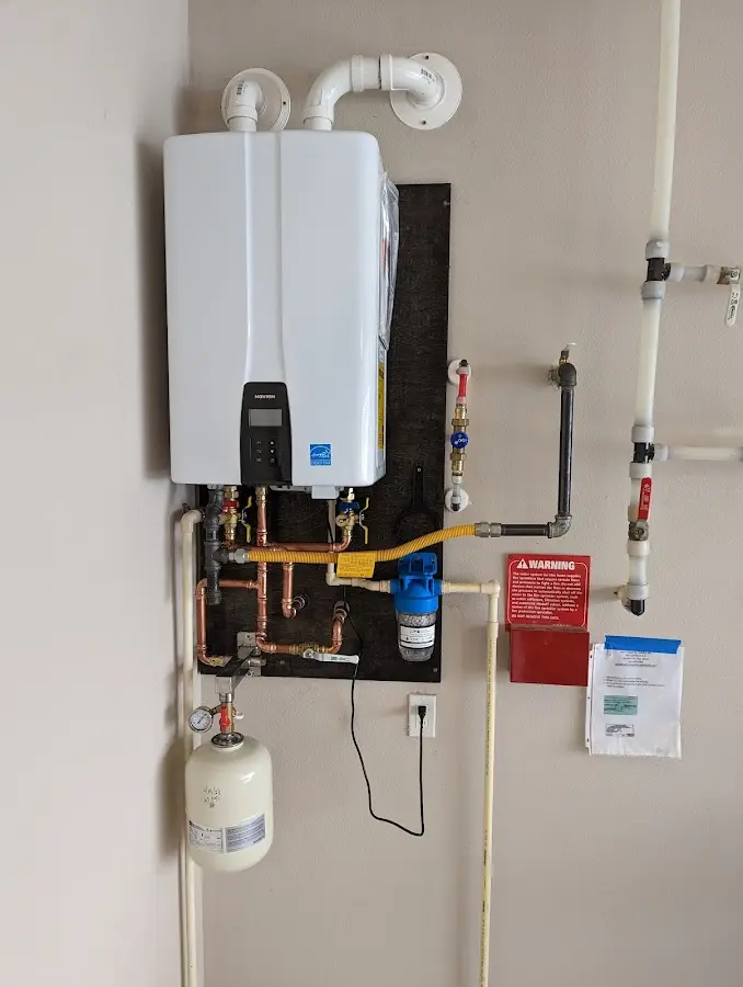 Professional plumber installing copper piping in a Air Force Academy home